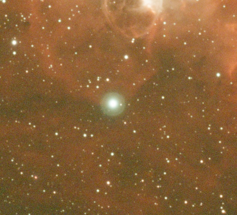 Emission nebula with a bright star surrounded by a green reflection halo